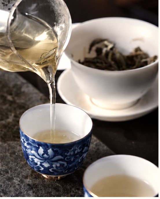 Tea poured from the pitcher into cups